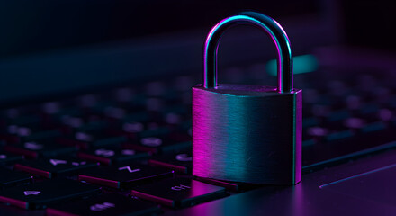 Cybersecurity Theme Padlock on Laptop Keyboard with Pink and Blue Lighting and Data Protection Concept and Digital Safety