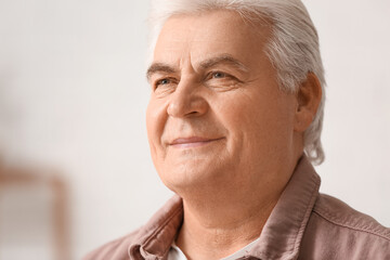 Portrait of handsome senior man at home, closeup
