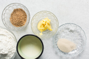 Overhead view of ingredients for making soft pretzels, top view of mise en place of ingredients for making pretzels, process of making soft pretzels