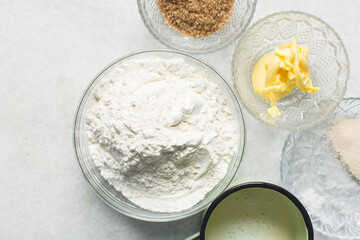 Overhead view of ingredients for making soft pretzels, top view of mise en place of ingredients for making pretzels, process of making soft pretzels