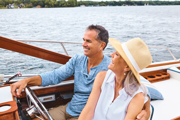 Happy couple, ocean adventure and together in yacht on holiday, relax on cruise date for retirement...