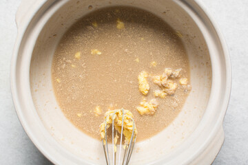 Overhead view of ingredients for making homemade pretzels dough being mixed in a bowl