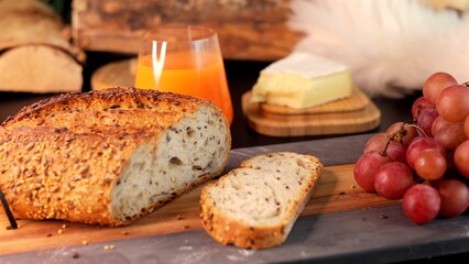 Freshly baked bread, bunches of grapes, orange juice evoke farmers market feel, showcasing natural, unprocessed ingredients, ideal for promoting organic food, farm-fresh produce, healthy lifestyle.