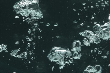 Many water bubbles on dark background, closeup