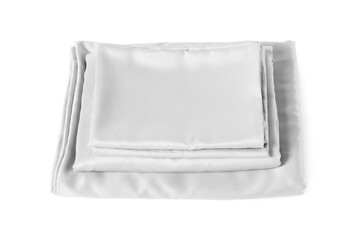 Stack of silky bed linens on white background, above view