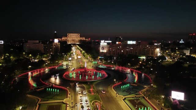 Aerial view in Bucharest at unirii with casa poporului and fountain lights in the background on a warm summer night