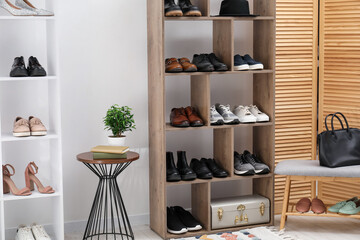 Shoe storage. Shelving units with different footwear and accessories indoors