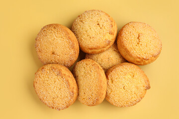 Many sweet cookies on yellow background
