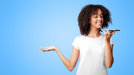 Voice command, search engine and mobile app. Cheerful emotional teen african american lady hold phone and making call or sings in audio app, isolated on purple background, free space, studio shot