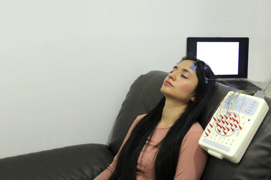 Electroencephalogram on a 20-year-old latin woman to measure brain electrical activity and diagnose brain problems, such as epilepsy and sleep disorders