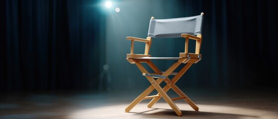 Obraz premium Empty director's chair under spotlight on stage.