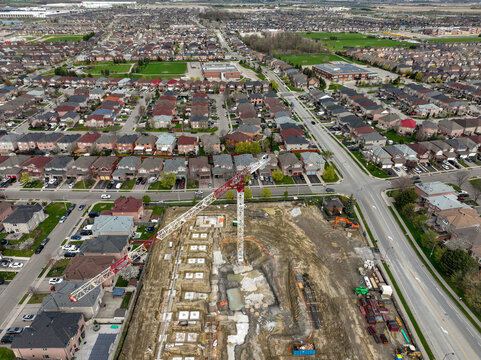 A new multi storey building rises in a Brampton Ontario suburban neighbourhood, highlighting the potential for tension between community growth and local resistance to development.