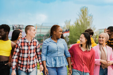 Diverse group of friends having fun smiling outdoor in summer day. Young people celebrate holiday vacations outside