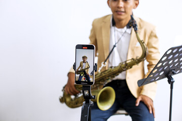 Naklejka premium Happy Vlog Musician Man Blogger Using Smartphone Talking On Video Streaming