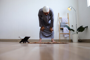 Low Angle Of Muslim Male Wearing Skullcap Showing Ruku In Salah Movement