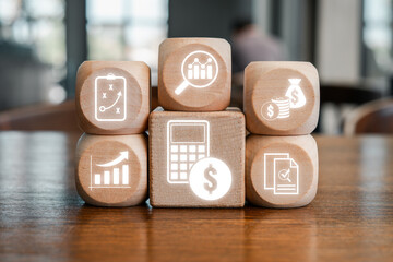 Wooden blocks with financial and analytical icons representing the concept of calculation and business strategy.
