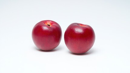 Two ripe red nectarines on white background fresh juicy summer fruit