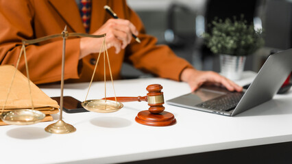 An elderly Caucasian male lawyer works at his desk in a law firm, offering legal advice and business law services. A gavel and documents symbolize justice and professionalism