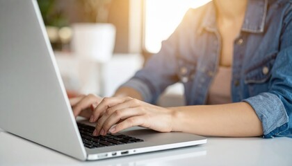 Fototapeta premium A focused woman with long brown hair, wearing a cozy sweater, types intently on her sleek laptop, surrounded by books and a steaming cup of coffee.