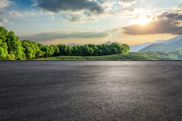  Empty asphalt road and green tea plantation with mountain natural landscape at sunset © ABCDstock