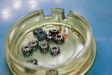 Intricate clockwork gears resting in a glass tray under soft ambient light during a creative...