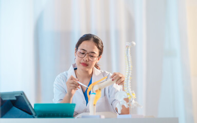  Asian Medical Student Studying Anatomical Model.