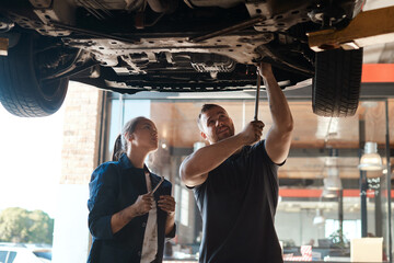 Mechanic, garage and tools for car with training, maintenance engineer and teamwork at workplace....