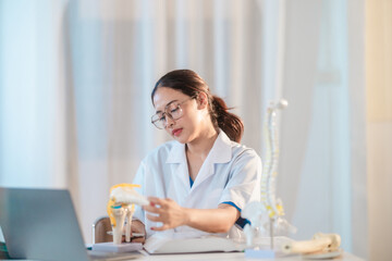  Asian Medical Student Studying Anatomical Model.