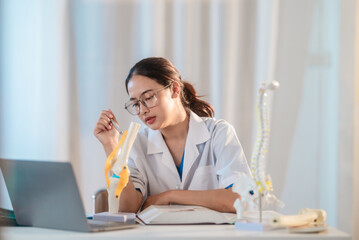  Asian Medical Student Studying Anatomical Model.