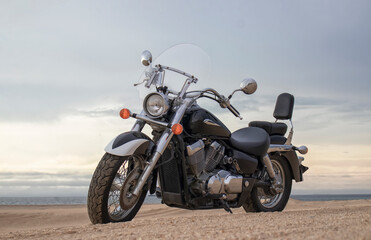Off-road motorcycle parked in the desert under dramatic cloudy sky — adventure, travel, freedom, and extreme outdoor landscape concept