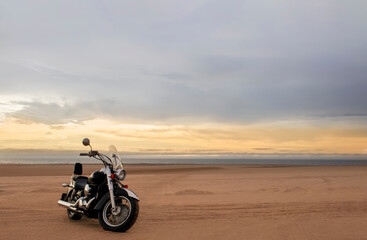 Off-road motorcycle parked in the desert under dramatic cloudy sky — adventure, travel, freedom, and extreme outdoor landscape concept