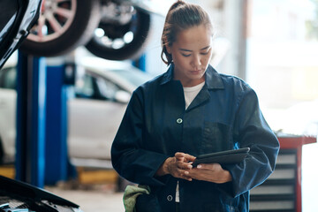 Tablet, checklist and woman in garage with car service, maintenance or online motor insurance. Tech, engine and female mechanic in workshop on digital app for inspection, repair and quality assurance