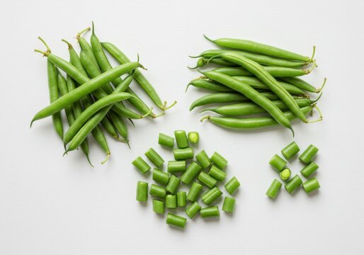 Arrangement of whole and cut green beans on a white background
