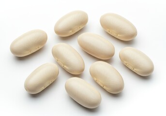 Pile of white beans on a white surface in a studio shot