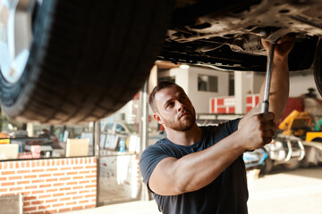 Maintenance, mechanic and tools for car service in workshop for repair and inspection. Roadworthy, handyman and working on vehicle in garage for performance, transportation and test tire for safety
