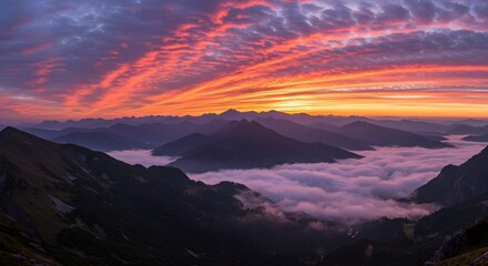 Fototapeta premium Misty mountain range with dramatic clouds at sunrise (horizontal). 