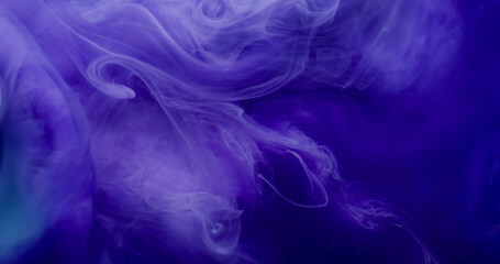 Splash art. Liquid texture. Defocused purple blue color smoke wet acrylic substance chemical ink fluid spilling on abstract background.