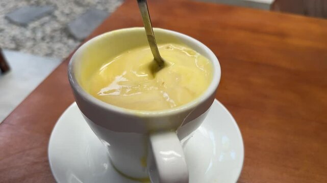 passion fruit juice Human Hand Stirring Powdered Juice Drink In cup Close-up Shot