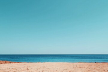 Obraz premium Serene Seascape Tranquil Ocean View with Sandy Beach under a Clear Blue Sky