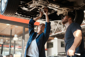 Mechanic, garage work and tools for car with training, maintenance engineer and teamwork at...