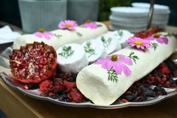 cheeses with dried fruits, buffet food in a restaurant, haute cuisine, brie cheese with pomegranate and fruits, pomegranate and dried fruits, brie cheese, brie 