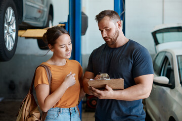 Woman, mechanic and sign quote in auto repair shop, invoice and service for car maintenance bill....