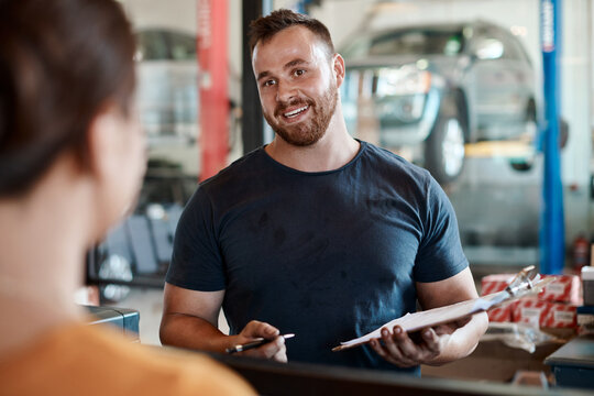 Mechanic, man and customer talk with car report and clipboard for maintenance and repair check. Conversation, garage and motor inspection with paperwork and auto consultation for technician job - Powered by Adobe