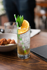 Tall Orange Cocktail At A Restaurant