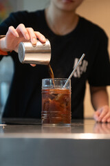 Barista Pouring Iced Black Coffee