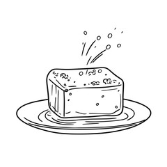 Block of cheese served on a plate with seasoning sprinkled  