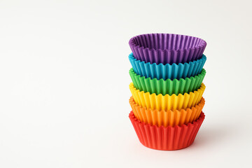 A vibrant stack of silicone cupcake liners in various colors, including purple, green, yellow, and red