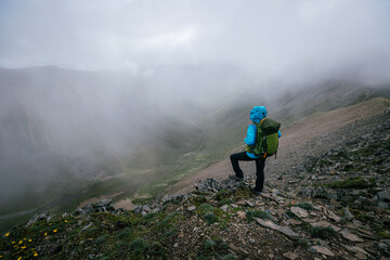 Woman hiker backpacking on mountain top