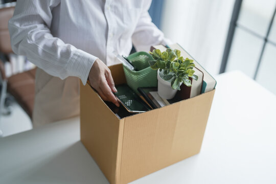 Quit Job senior asian business woman sending resignation letter and packing Stuff Resign Depress or carrying business cardboard box in office layoff retired from company