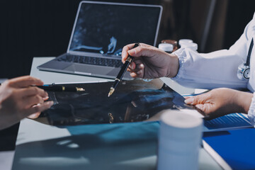 Male and female doctors are having a meeting in a hospital room.